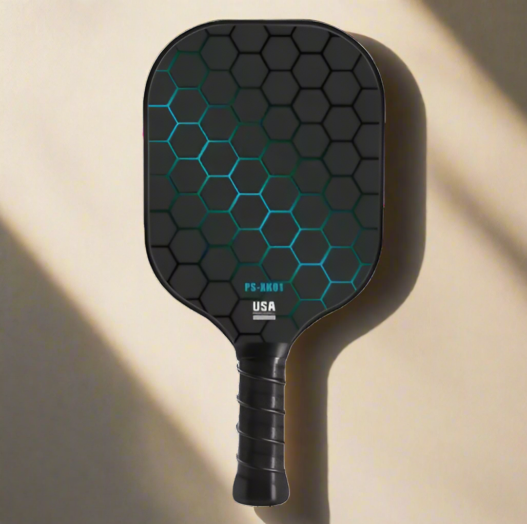 Black pickleball paddle with hexagonal pattern on a white background
