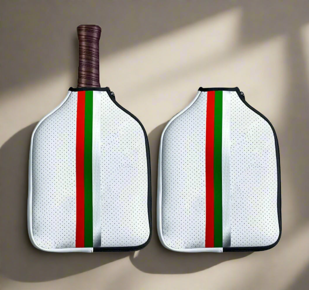Pickleball paddle cover with red, green and white stripes joined together, with a white polka dot background.