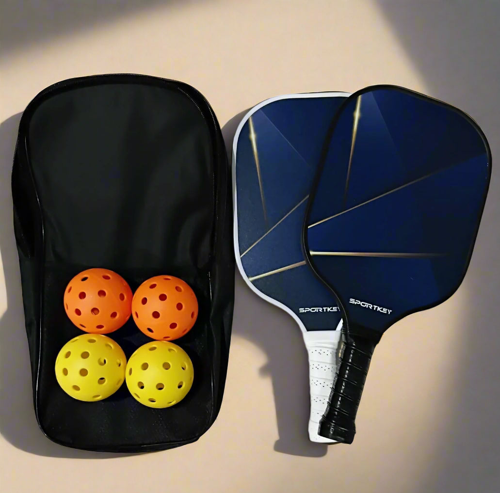 Shooting star design Pickleball Paddle Set of 2 with 2 paddles, 2 orange indoor balls and two yellow outdoor balls and a bag.
