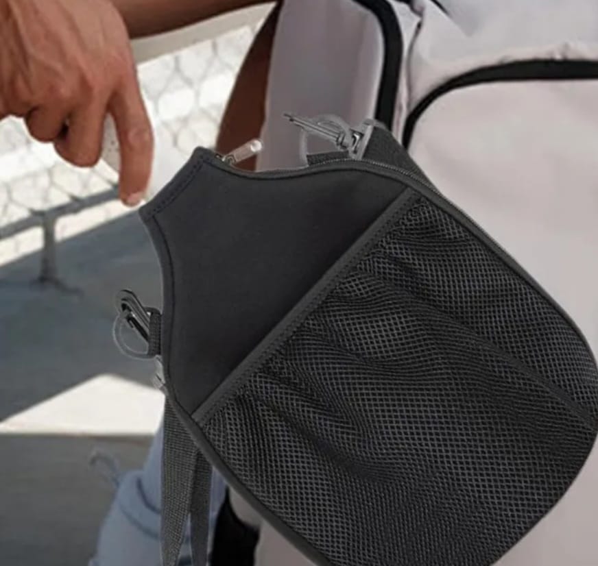 Picture showing a guy wearing the pickleball sling bag with a paddle inside.