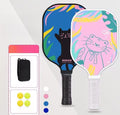 Two colorful pickleball paddles with cat designs, a bag, and balls on a light gray background.