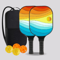 Two colorful pickleball paddles with a black bag and balls on a light gray background