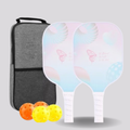 Two pickleball paddles with colorful designs and4  pickleballs in front of a gray carrying case on a light gray background.