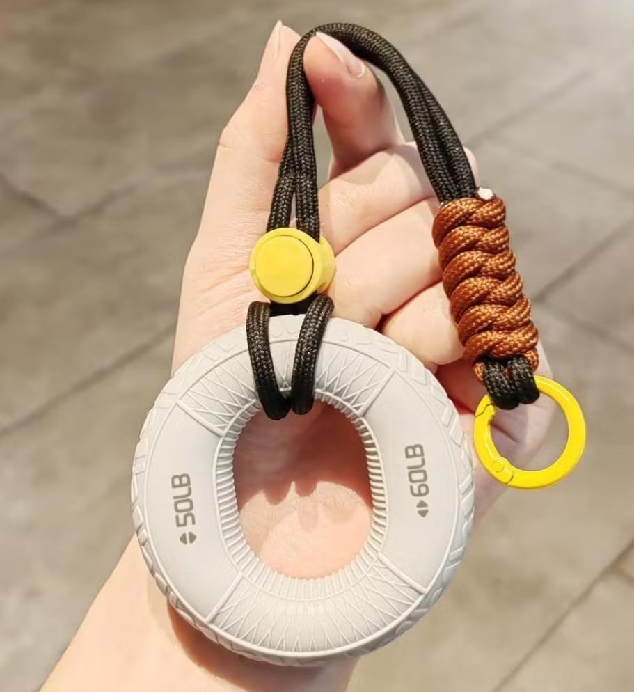 Hand holding hand grip trainer