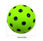 Green ball with black dots and measurements of 74mm/2.91in on a white background