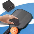 Image shows person using a pickleball eraser to clean the paddle.