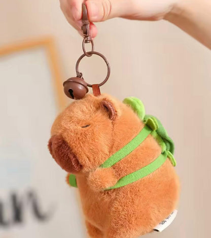 Capybara keychain with a small green turtle backpack