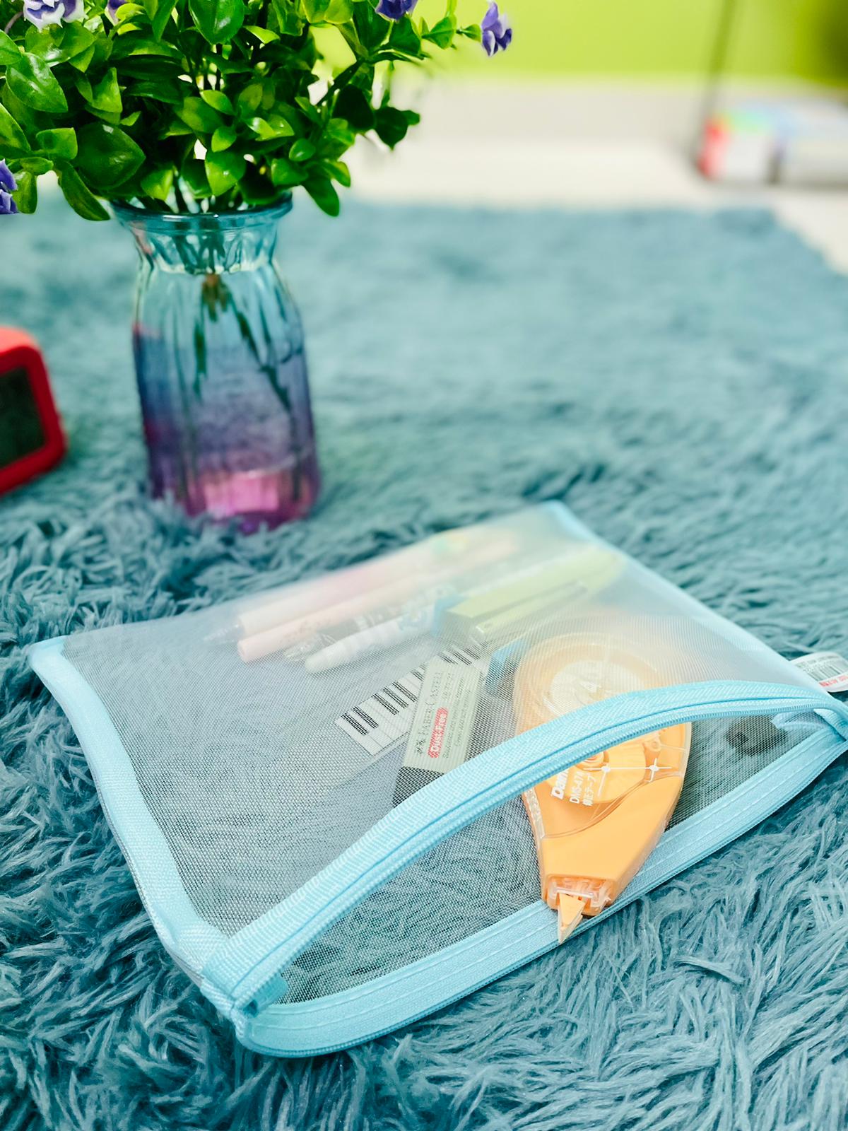 Light blue pencil case with some stationeries inside