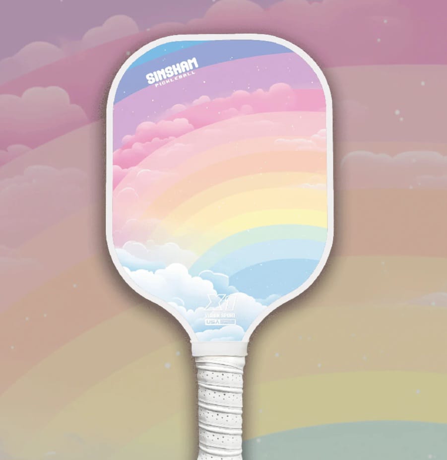 Single Pickleball Paddle with a rainbow design about 12 colours: Red , different shades of oranges, yellow, green, blue, pink,  purples with faded clouds behind. 